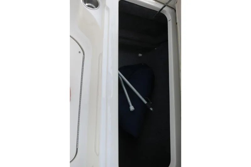 Slide: The Image of Storage compartment of a 2008 Sea Ray 260 Sundeck boat with metal poles inside. - 18
