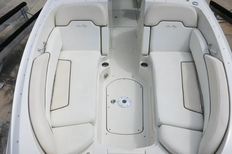 Slide: The Image of 2008 Sea Ray 260 Sundeck interior with white cushioned seating and sleek design. - 22