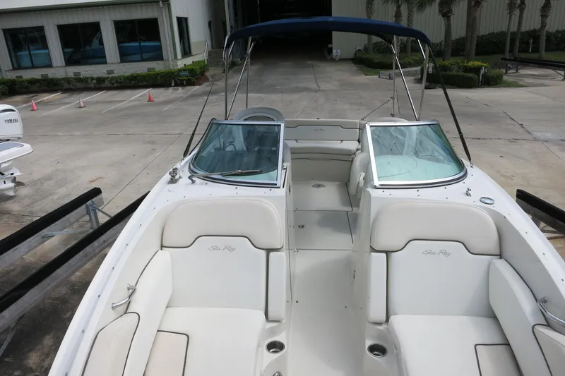 Slide: The Image of 2008 Sea Ray 260 Sundeck boat with white seating and open deck layout. - 23