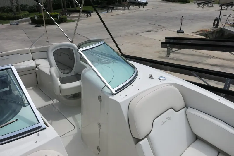 Slide: The Image of 2008 Sea Ray 260 Sundeck boat interior with white seating and windshield. - 25