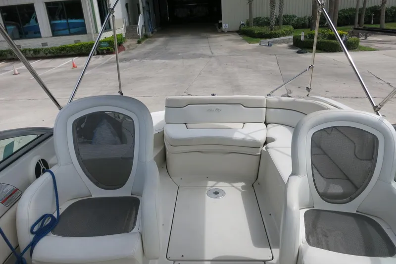 Slide: The Image of 2008 Sea Ray 260 Sundeck interior with white seating and open deck layout. - 26
