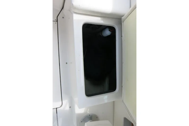 Slide: The Image of Storage compartment inside 2008 Sea Ray 260 Sundeck boat, featuring white interior design. - 29