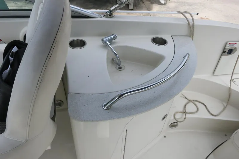 Slide: The Image of 2008 Sea Ray 260 Sundeck boat interior with sink and seating area. - 30