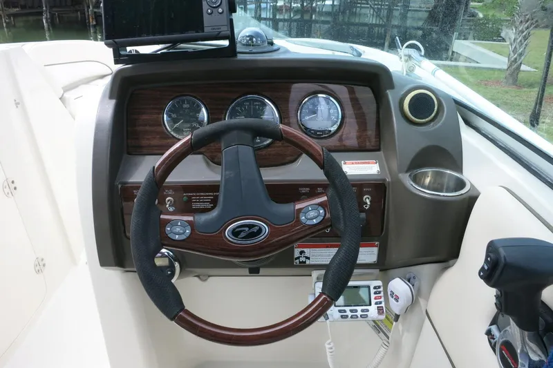 Slide: The Image of Dashboard of a 2008 Sea Ray 260 Sundeck boat with steering wheel and gauges. - 31