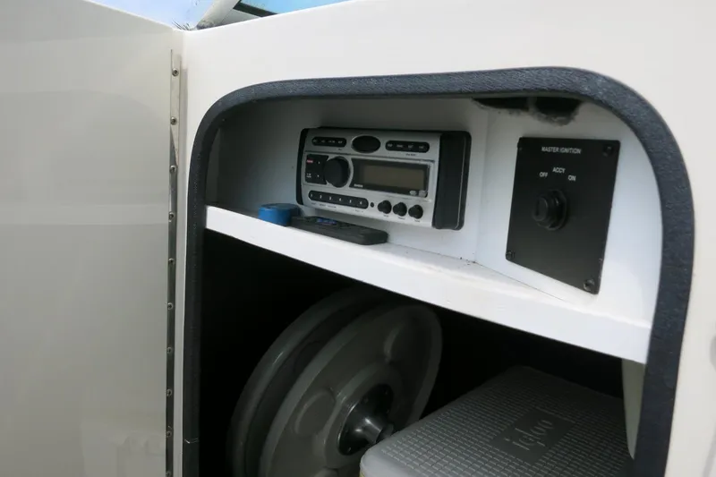 Slide: The Image of Storage compartment in a 2008 Sea Ray 260 Sundeck with radio and ignition controls. - 32