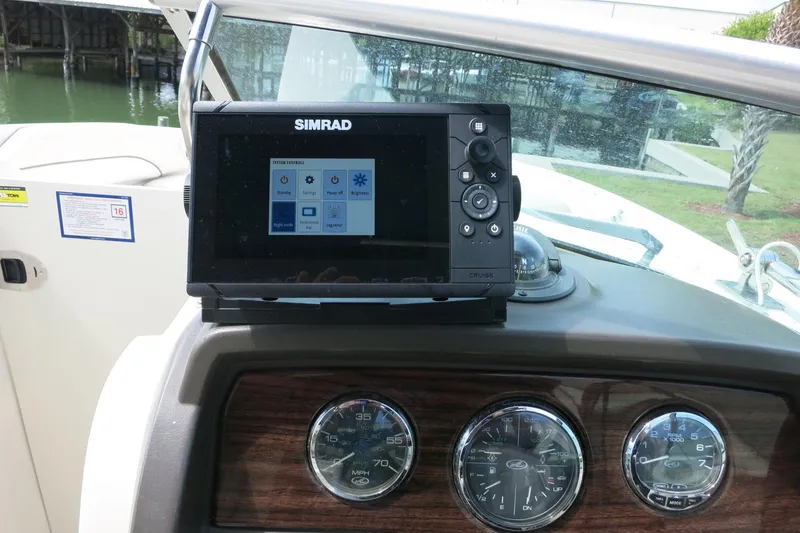 Slide: The Image of Simrad navigation system on 2008 Sea Ray 260 Sundeck dashboard with gauges. - 36
