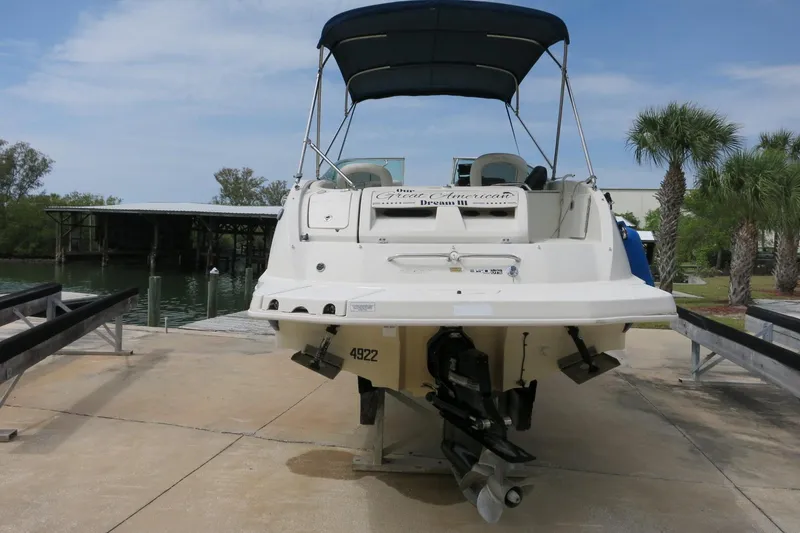 Slide: The Image of 2008 Sea Ray 260 Sundeck boat on trailer, dockside with palm trees. - 7