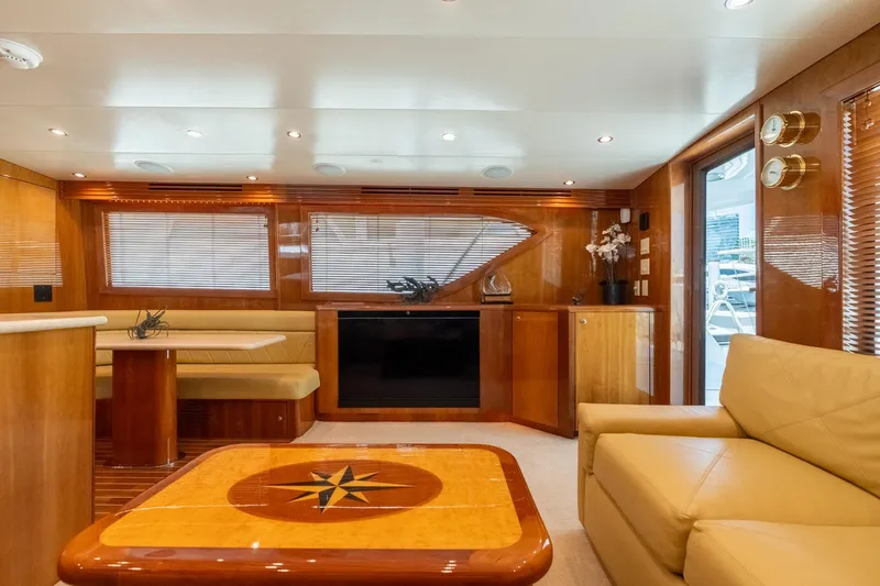 Slide: The Image of Luxurious interior of 2004 Hatteras 60 Convertible yacht with elegant wood finishes and plush seating. - 18