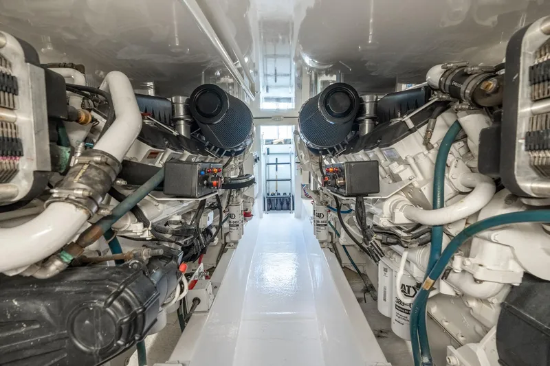 Slide: The Image of Engine room of 2004 Hatteras 60 Convertible yacht, showcasing dual engines and mechanical systems. - 40
