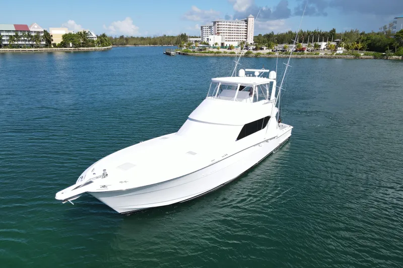 Slide: The Image of 2004 Hatteras 60 Convertible yacht cruising in a scenic coastal waterway. - 22