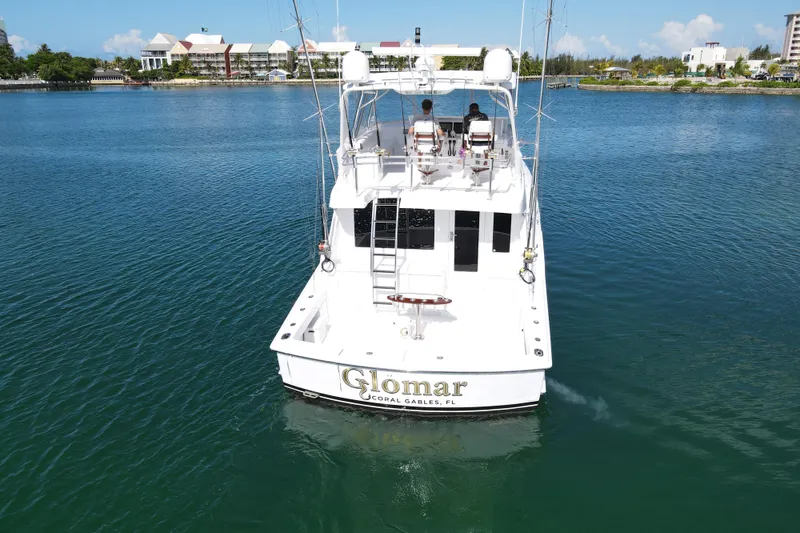 Slide: The Image of 2004 Hatteras 60 Convertible yacht on calm water, rear view. - 31