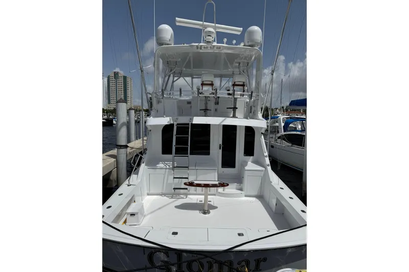 Slide: The Image of 2004 Hatteras 60 Convertible yacht docked at marina, rear view with fishing deck. - 39