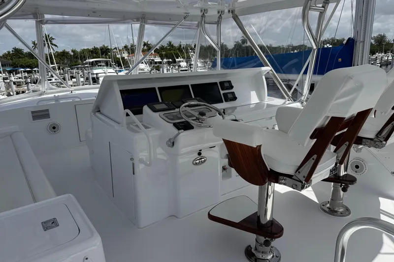 Slide: The Image of Helm of 2004 Hatteras 60 Convertible yacht with modern controls and seating. - 45
