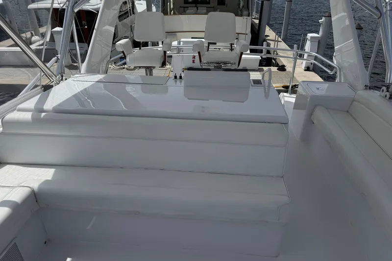 Slide: The Image of 2004 Hatteras 60 Convertible yacht deck with seating and helm station. - 48