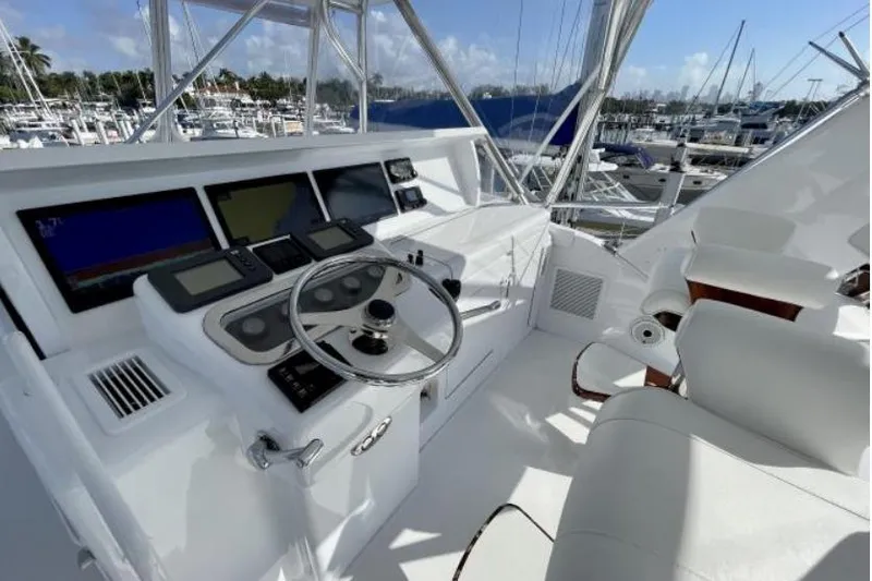 Slide: The Image of Helm of 2004 Hatteras 60 Convertible yacht with modern navigation equipment and luxurious seating. - 50