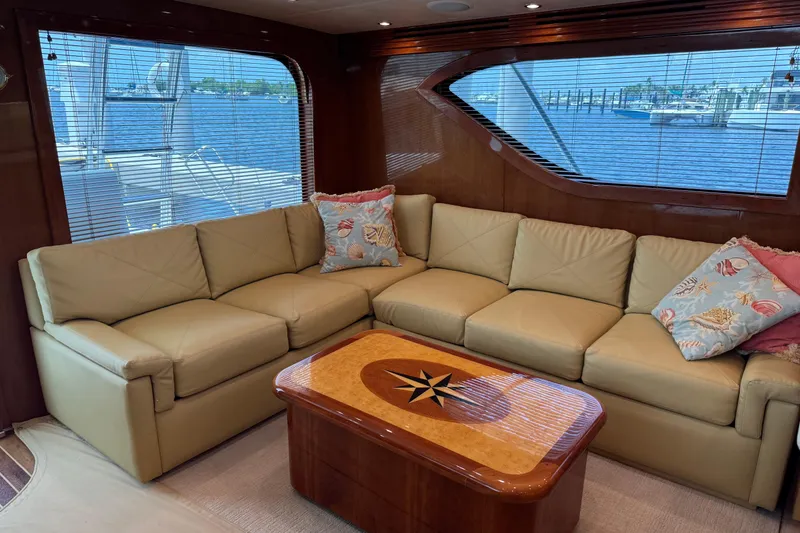 Slide: The Image of Luxurious interior of 2004 Hatteras 60 Convertible yacht with beige leather sofa and nautical decor. - 52