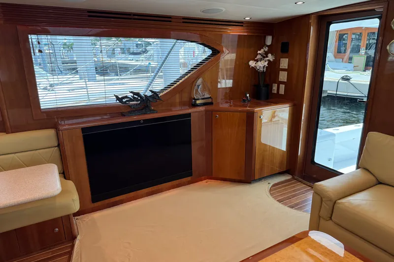 Slide: The Image of Luxurious interior of a 2004 Hatteras 60 Convertible yacht with elegant wood finishes. - 53