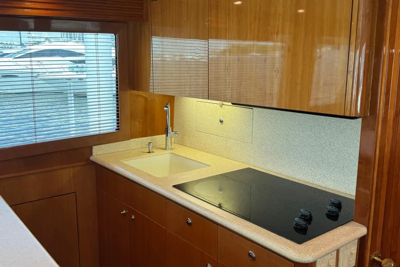 Slide: The Image of Luxurious kitchen interior of 2004 Hatteras 60 Convertible yacht with modern amenities. - 56