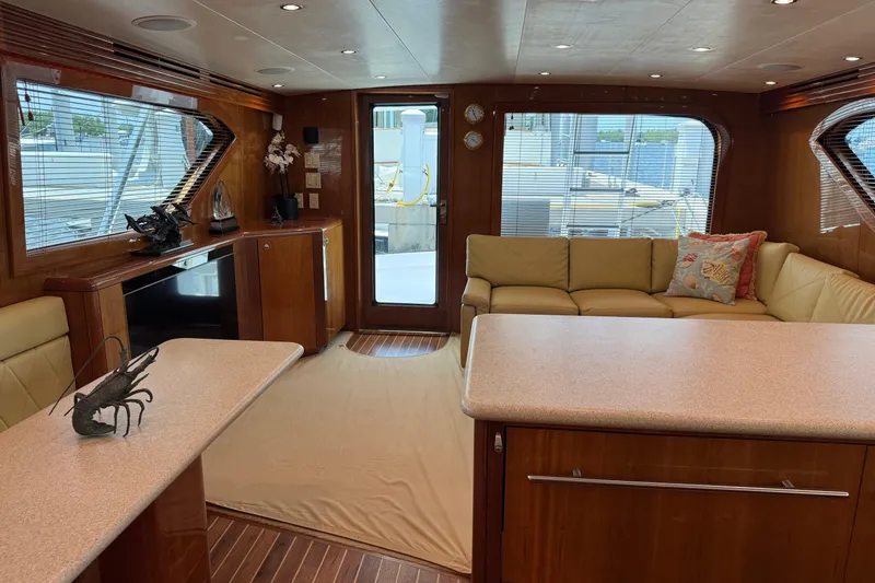 Slide: The Image of Luxurious interior of 2004 Hatteras 60 Convertible yacht with elegant wood finishes and plush seating. - 57