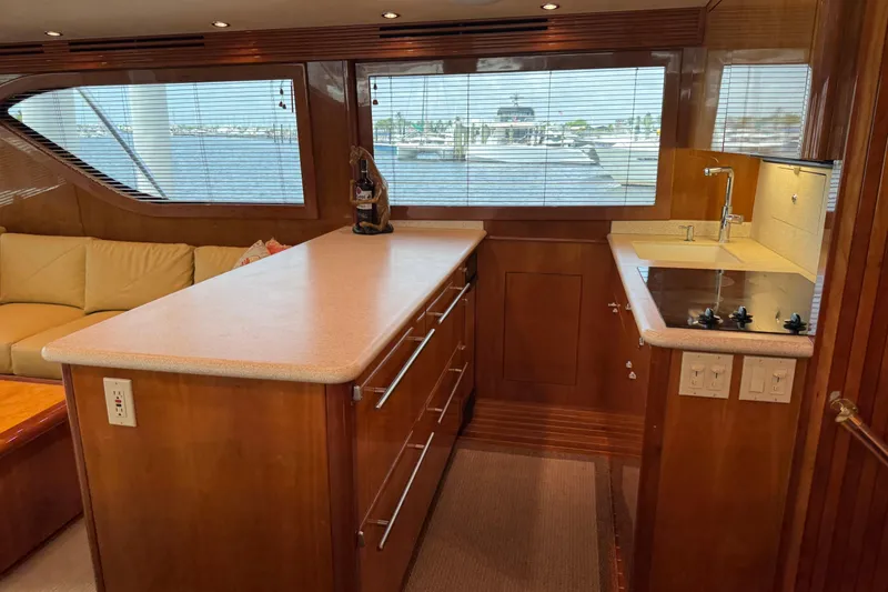 Slide: The Image of Luxurious 2004 Hatteras 60 Convertible yacht interior with modern kitchen and scenic window views. - 58