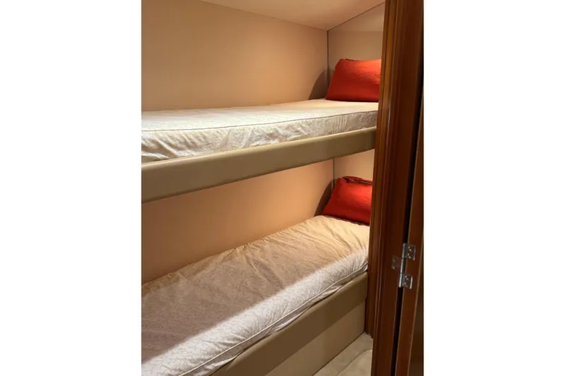 Slide: The Image of Bunk beds with red pillows in 2004 Hatteras 60 Convertible yacht cabin. - 59