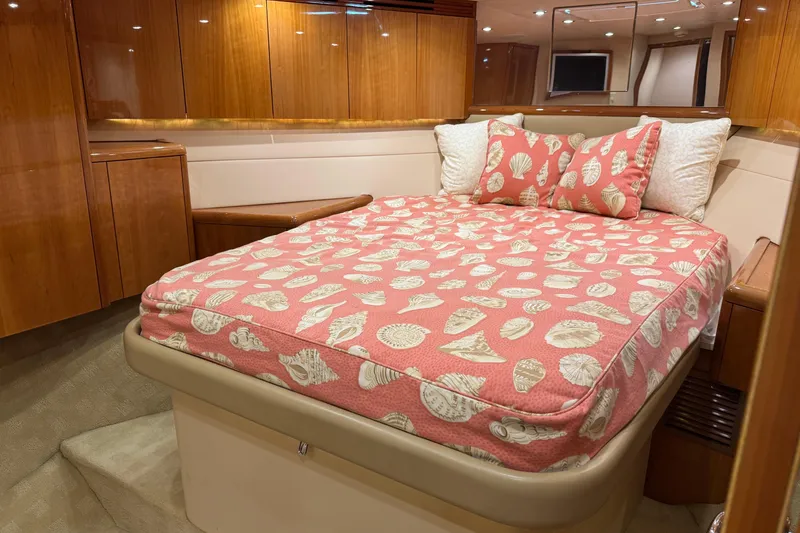 Slide: The Image of Luxurious cabin interior of 2004 Hatteras 60 Convertible yacht with seashell-themed bedding. - 60