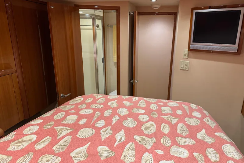 Slide: The Image of Bedroom interior of 2004 Hatteras 60 Convertible yacht with seashell-patterned bedding. - 61