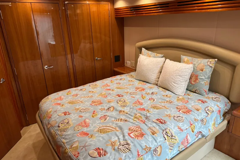 Slide: The Image of Luxurious bedroom in 2004 Hatteras 60 Convertible yacht with seashell-themed bedding. - 63