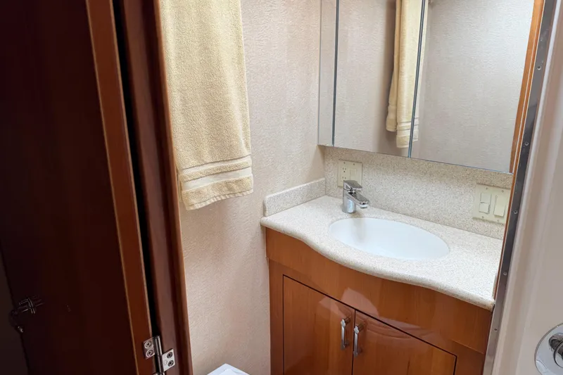 Slide: The Image of Bathroom vanity with mirror and sink on 2004 Hatteras 60 Convertible yacht. - 68