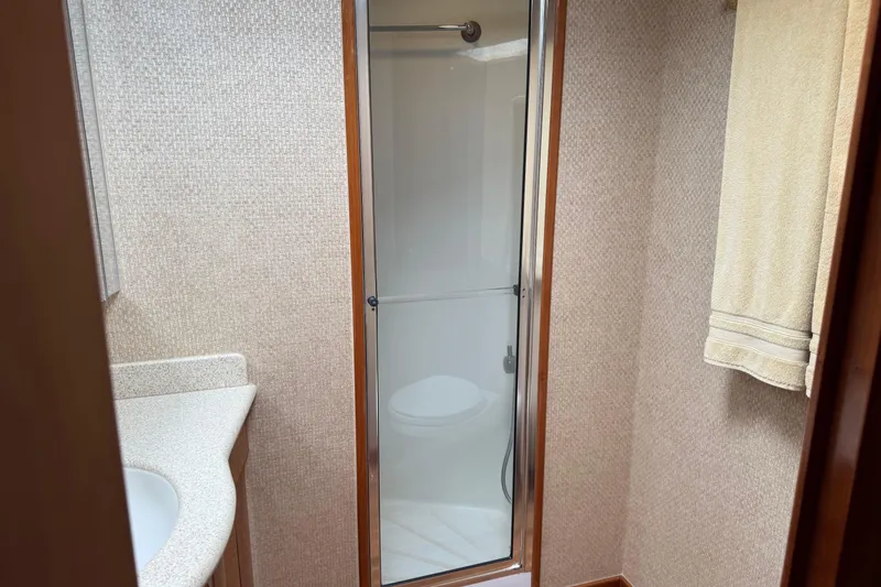 Slide: The Image of Bathroom interior of a 2004 Hatteras 60 Convertible yacht with shower and sink. - 71