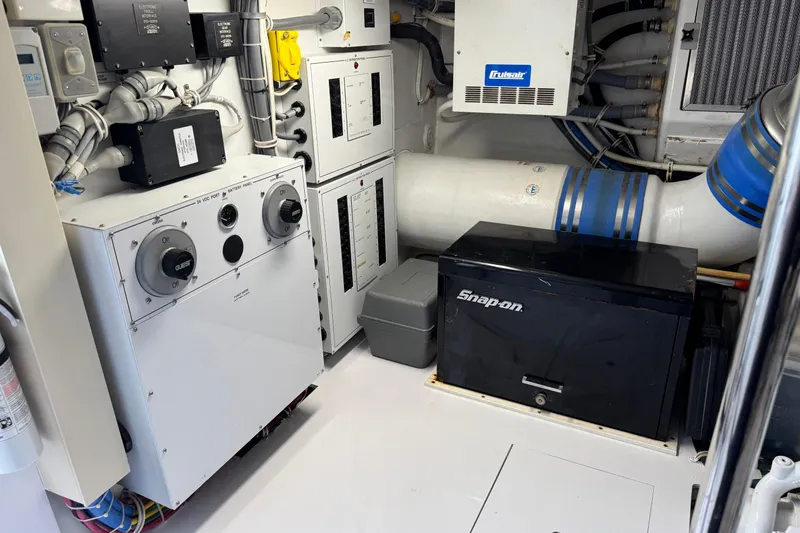 Slide: The Image of Engine room of 2004 Hatteras 60 Convertible yacht with electrical panels and Snap-on toolbox. - 73