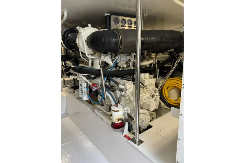 Slide: The Image of Engine room of 2004 Hatteras 60 Convertible yacht, showcasing detailed machinery and components. - 75