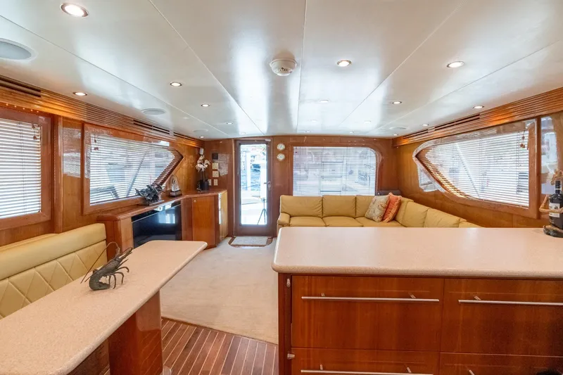 Slide: The Image of Luxurious interior of 2004 Hatteras 60 Convertible yacht with elegant wood finishes and plush seating. - 24