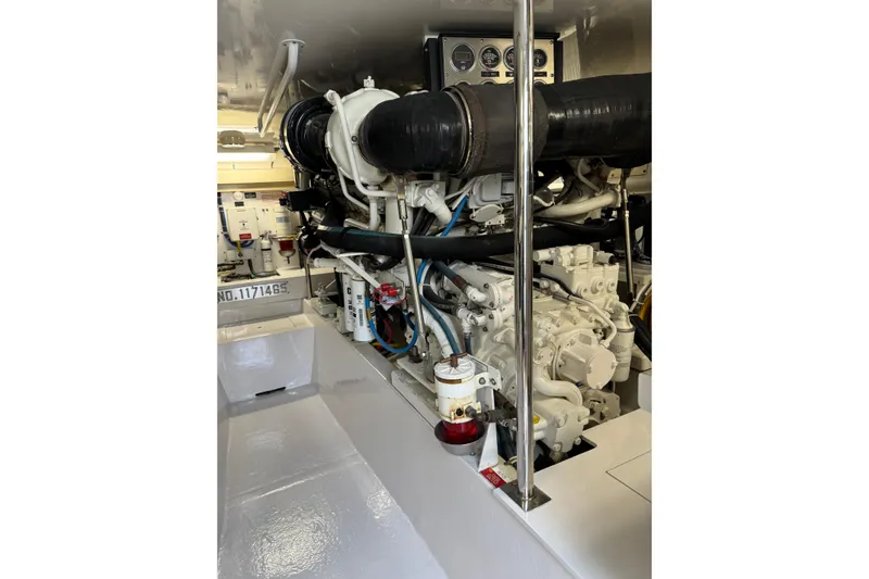 Slide: The Image of Engine room of 2004 Hatteras 60 Convertible yacht, showcasing detailed machinery and components. - 76