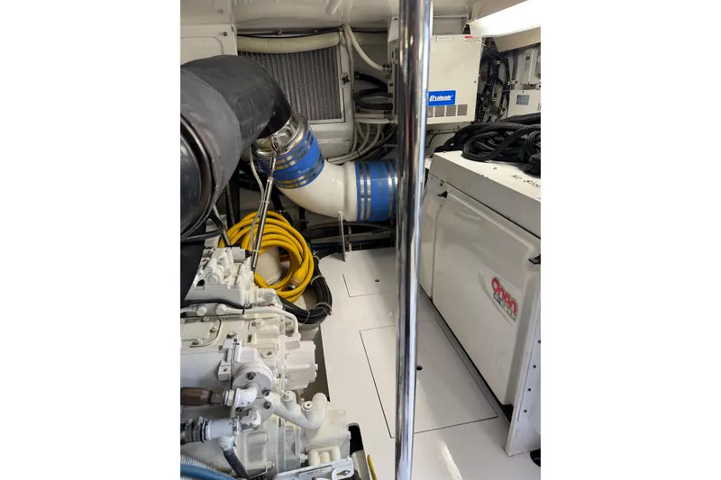 Slide: The Image of Engine room of 2004 Hatteras 60 Convertible yacht with visible machinery and equipment. - 77