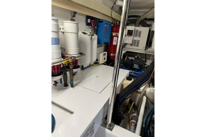 Slide: The Image of Engine room of 2004 Hatteras 60 Convertible yacht with mechanical equipment and piping. - 78