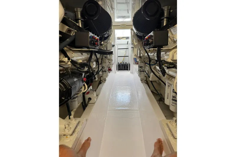 Slide: The Image of Engine room of a 2004 Hatteras 60 Convertible yacht, showcasing machinery and components. - 79