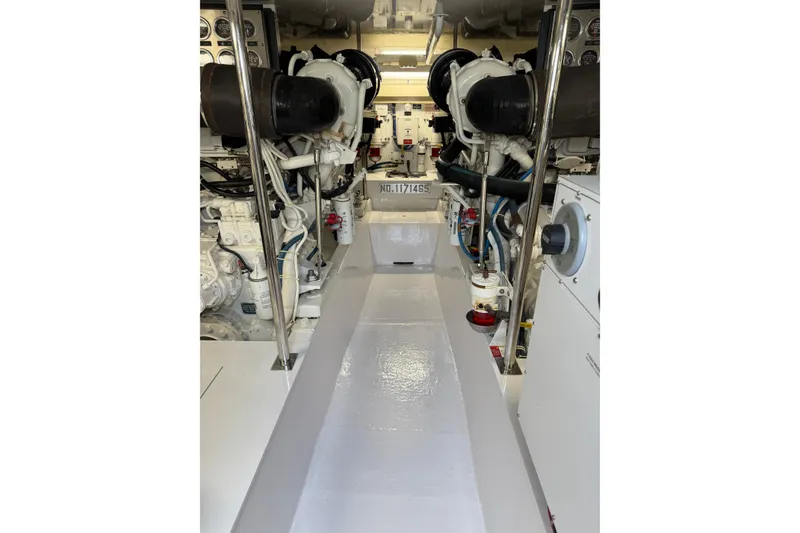 Slide: The Image of Engine room of 2004 Hatteras 60 Convertible yacht, showcasing dual engines and mechanical systems. - 80
