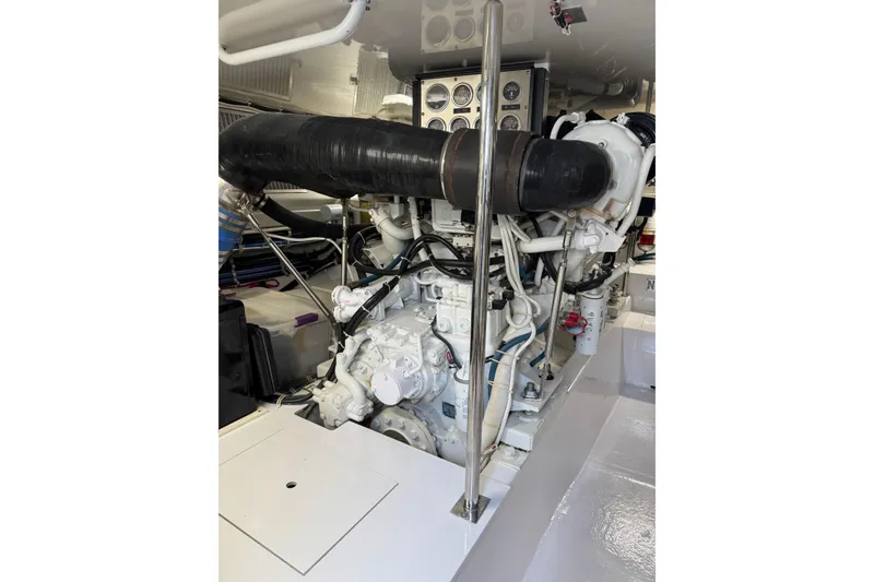 Slide: The Image of Engine room of 2004 Hatteras 60 Convertible yacht, showcasing detailed machinery and components. - 81