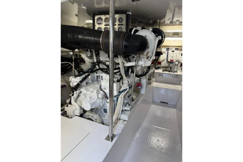 Slide: The Image of Engine room of a 2004 Hatteras 60 Convertible yacht, showcasing machinery and components. - 82