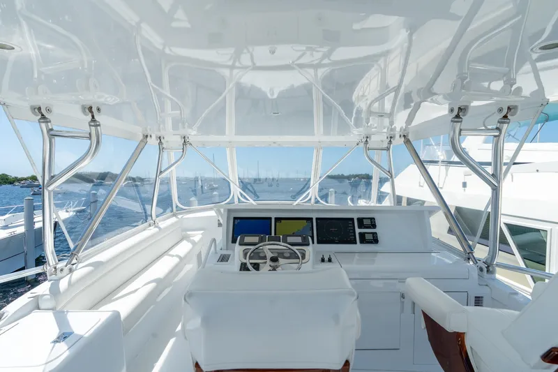 Slide: The Image of Cockpit view of 2004 Hatteras 60 Convertible yacht with navigation equipment and ocean backdrop. - 3