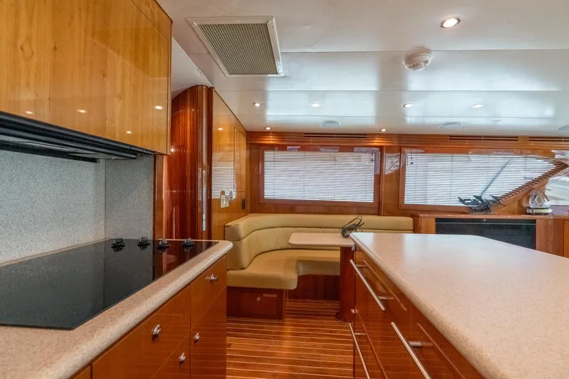 Slide: The Image of Luxurious interior of 2004 Hatteras 60 Convertible yacht with modern kitchen and seating area. - 21