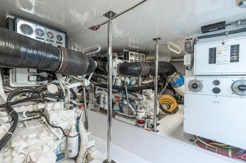Slide: The Image of Engine room of 2004 Hatteras 60 Convertible yacht, showcasing machinery and control panels. - 45