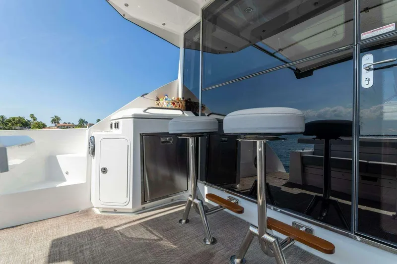 Slide: The Image of 2018 Cruisers Cantius 45 yacht deck with bar stools and ocean view. - 11