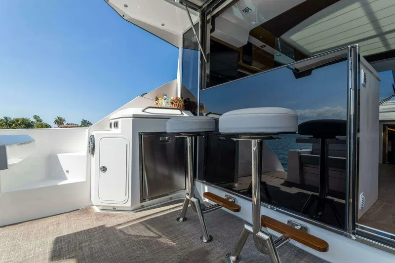 Slide: The Image of 2018 Cruisers Cantius 45 yacht deck with bar stools and ocean view. - 12
