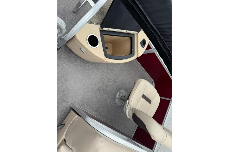 Slide: The Image of 2019 Sun Tracker Bass Buggy 18 DLX interior with beige seating and storage compartment. - 10