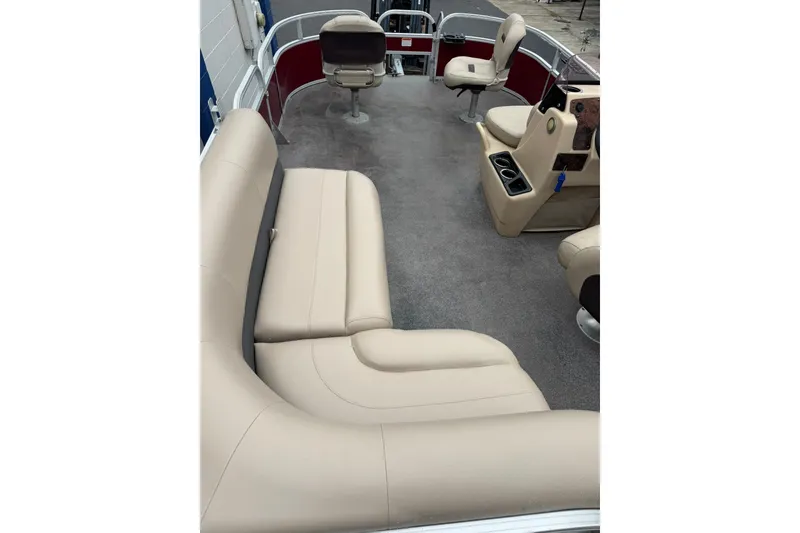 Slide: The Image of 2019 Sun Tracker Bass Buggy 18 DLX interior with beige seating and carpeted floor. - 11