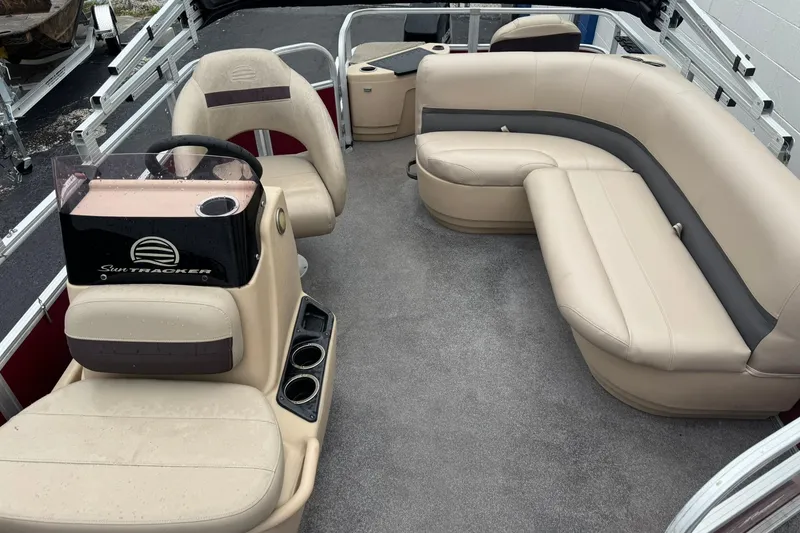 Slide: The Image of 2019 Sun Tracker Bass Buggy 18 DLX interior with beige seating and steering console. - 6