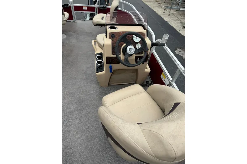 Slide: The Image of 2019 Sun Tracker Bass Buggy 18 DLX boat interior with steering wheel and seating. - 8