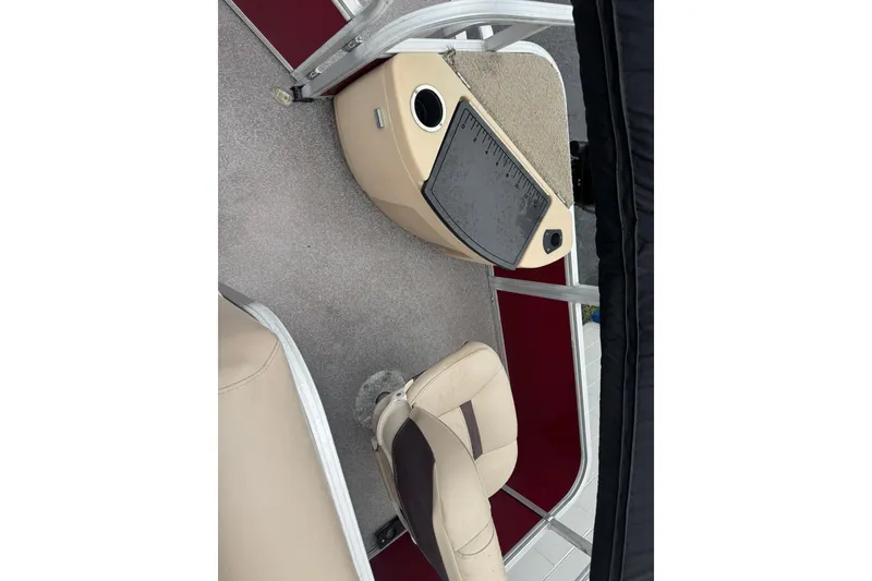 Slide: The Image of 2019 Sun Tracker Bass Buggy 18 DLX interior with beige seating and red accents. - 9